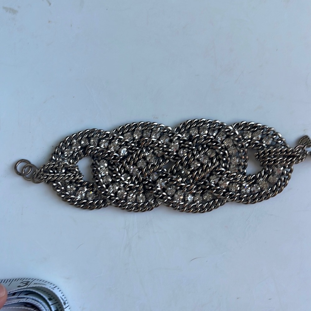 Silver colored metal clasp bracelet with white stones